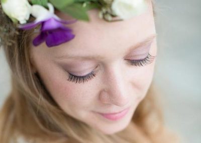 A woman with long hair wearing a flower crown.