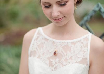 A woman in white dress looking down at her face.