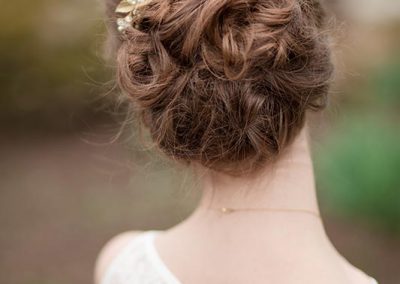 A woman with long hair and a gold hairpiece.