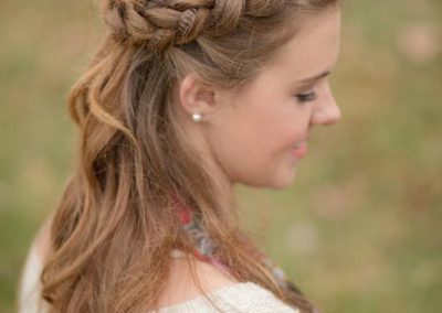 A woman with long hair and a braid in her hair.