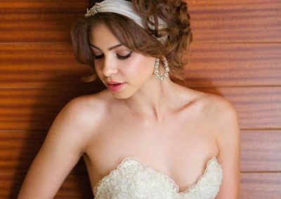 A woman in white dress sitting on the ground.