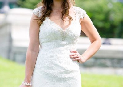 A bride in a white dress holding her bouquet.