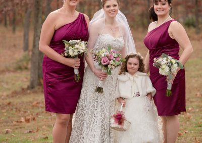 A bride and her bridesmaids posing for a picture.