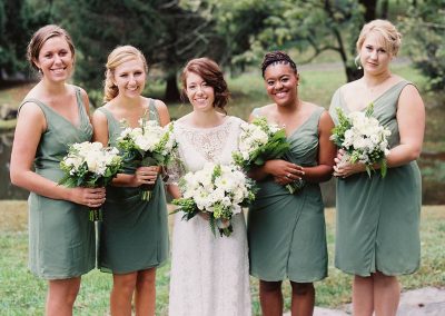 A group of women holding flowers in their hands.