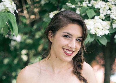 A woman with long hair and bare shoulders.