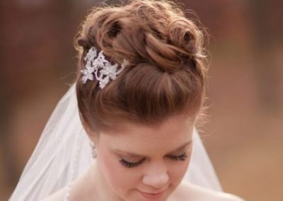 A bride with her hair in a bun and veil.