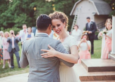 A man and woman dancing outside in front of people.