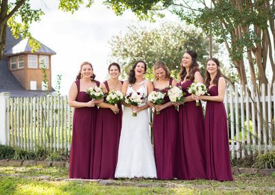 A group of women holding flowers in their hands.