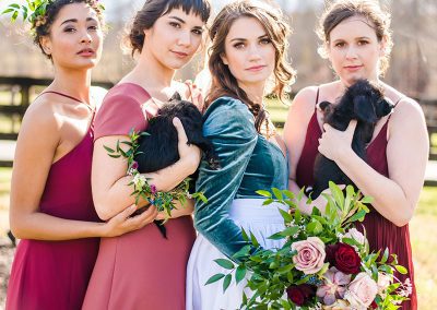 A group of women holding flowers and posing for the camera.