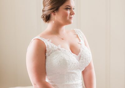 A bride in her wedding dress looking at the camera.