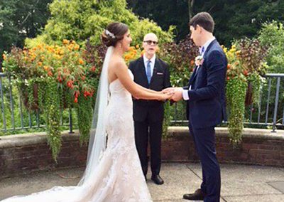 A man and woman holding hands in front of another man.