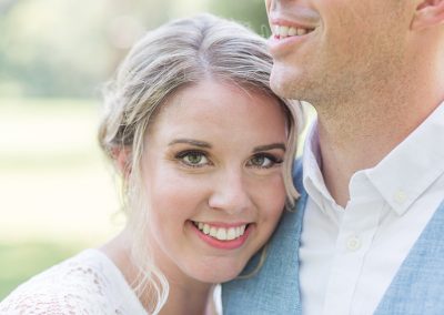 A close up of a person smiling with another person