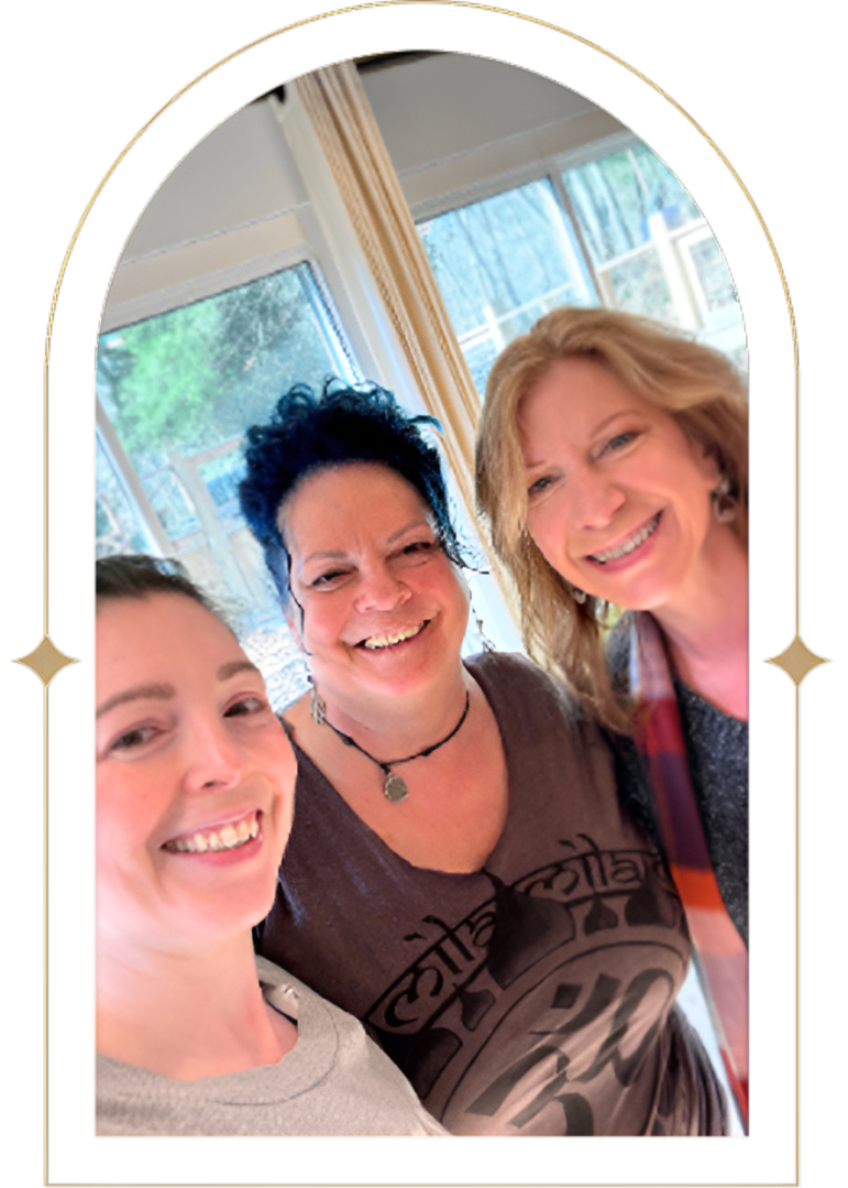 Three women smiling for a selfie.