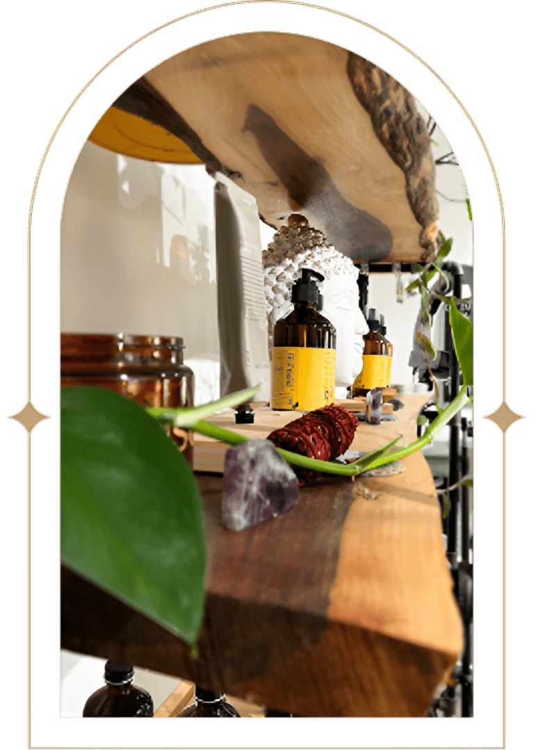 Wooden shelf with crystals, bottles and greenery.